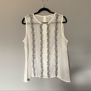 Ricki’s  white sheer sleeveless top with embroidered floral trim